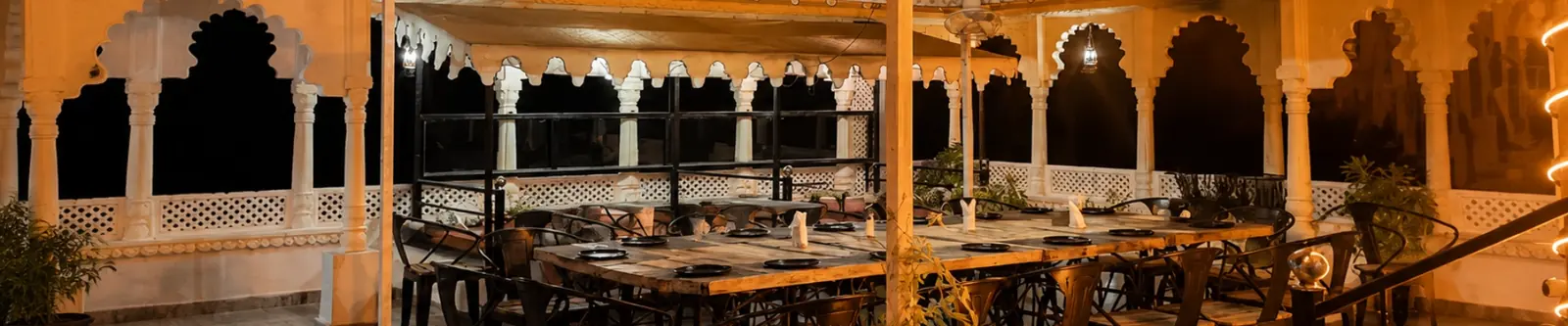The lantern-lit rooftop colonnade at Jaajam Restaurant, Udaipur
