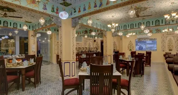 The indoor hall, laid for dinner — Jaajam Restaurant, Udaipur